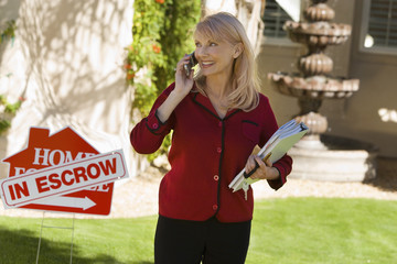 Lady holding papers with escrow sign as seller refuses to sign closing papers