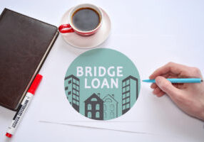 Bridge loan document with coffee and notebook
